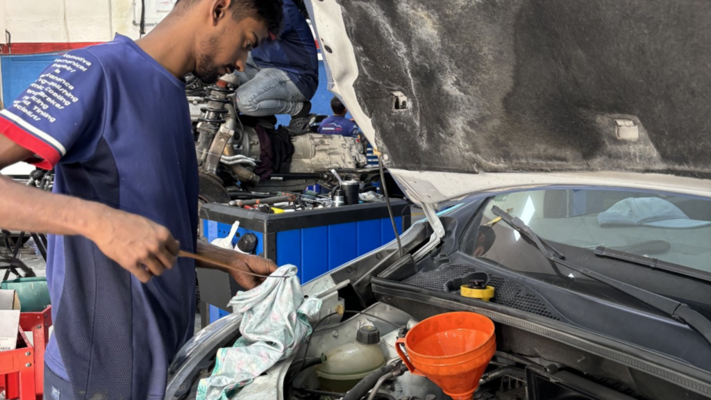 Techincian checking oil level 