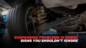 suspension problems Dubai mechanic inspecting car shock absorbers