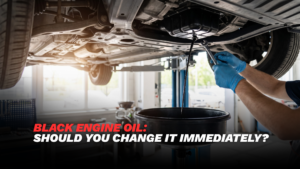 Technician checking black engine oil on a car dipstick during a vehicle inspection in Dubai
